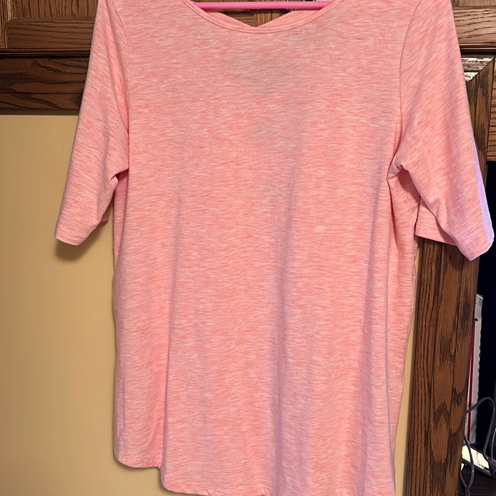 Shirt sleeve peachy colored.